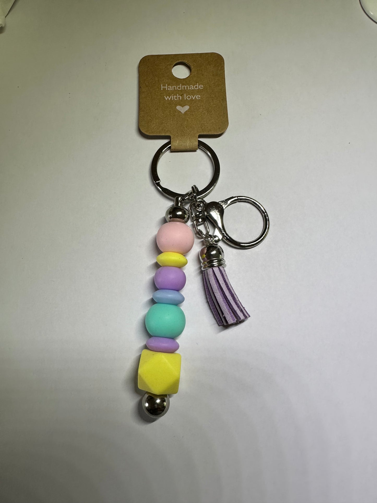 Geometric pastel keyring with purple tassel