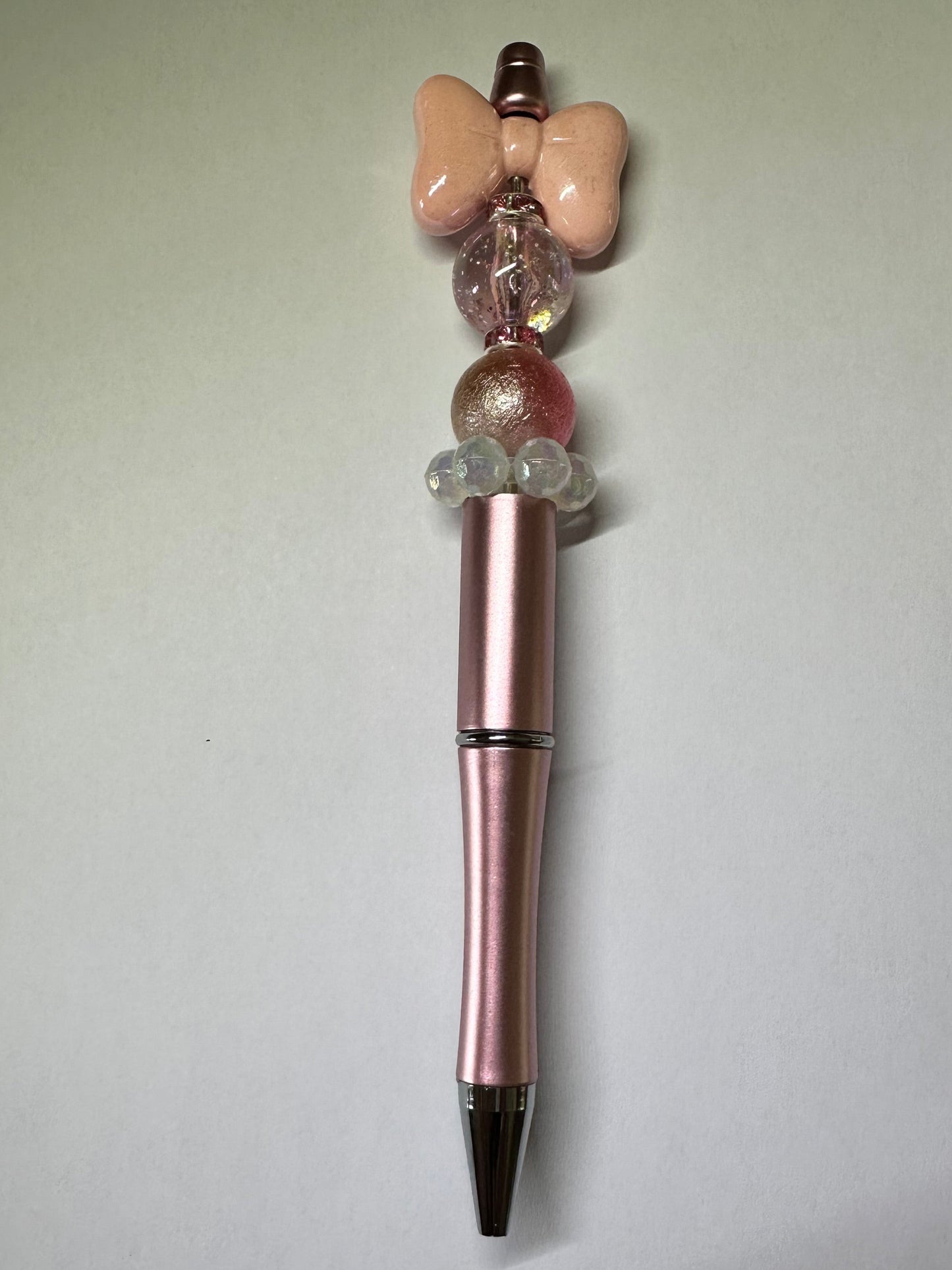 Metallic pink bow pen